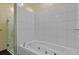 Clean bathroom featuring a deep soaking tub, glass-enclosed shower, and white tile at 805 Peachtree Ne St # 614, Atlanta, GA 30308