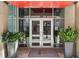 Modern building entrance featuring double doors, plants in large pots, and visible address signage at 805 Peachtree Ne St # 614, Atlanta, GA 30308