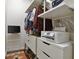 Organized closet with drawers, shelves, and clothing racks, plus a printer and TV at 805 Peachtree Ne St # 614, Atlanta, GA 30308