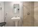 Modern bathroom featuring a pedestal sink and walk-in shower with gray tile and glass door at 490 Rockwell Sw St, Atlanta, GA 30310