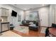 Cozy living room with a large, black leather sofa, hardwood floors and stainless steel dishwasher at 490 Rockwell Sw St, Atlanta, GA 30310