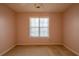 This is a bedroom with pink walls and a window with white blinds at 60 Riverside Pkwy, Sharpsburg, GA 30277