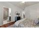 Bedroom with ensuite bathroom and a view of the living areas, featuring neutral decor and hardwood floors at 1250 Parkwood Se Cir # 2114, Atlanta, GA 30339