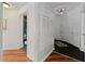 Hallway showcases a blend of hardwood and patterned floors, complemented by neutral-toned walls at 1250 Parkwood Se Cir # 2114, Atlanta, GA 30339