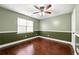 Bedroom features a ceiling fan, natural light, and hardwood floors at 100 Mountainside Ln, Covington, GA 30016