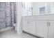 Bright bathroom featuring a double sink vanity with white cabinets, a tiled floor, and a tub-shower combination at 2845 Jims Ne Rd, Marietta, GA 30066