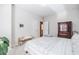 Cozy bedroom with neutral walls, carpet flooring, a wooden armoire, and a bench situated at the foot of the bed at 2845 Jims Ne Rd, Marietta, GA 30066
