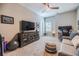 Comfortable bonus room with a ceiling fan, a TV console, ample seating, and a window overlooking the backyard at 2845 Jims Ne Rd, Marietta, GA 30066
