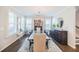 Spacious dining room featuring a long table, chandelier, and ample natural light through shuttered windows at 2845 Jims Ne Rd, Marietta, GA 30066