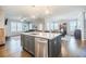 Open-concept kitchen with a central island featuring a sink, stainless steel dishwasher, and gray cabinetry at 2845 Jims Ne Rd, Marietta, GA 30066