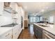 Modern kitchen featuring stainless steel appliances, gas range, tile backsplash, and a kitchen island with sink at 2845 Jims Ne Rd, Marietta, GA 30066