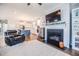 Cozy living room with a fireplace, flat-screen TV, and a view into the modern kitchen and dining areas at 2845 Jims Ne Rd, Marietta, GA 30066
