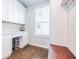 Mud Room features built-in white cabinets, a window and a wood bench with hardwood floors at 2845 Jims Ne Rd, Marietta, GA 30066