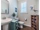 Stylish powder room boasts a pedestal sink, toilet and wooden shelf for decor at 2845 Jims Ne Rd, Marietta, GA 30066