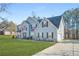 Two-story home with blue siding, black shutters, attached garage, and a meticulously maintained lawn at 2040 Winding Circle Trl, Fairburn, GA 30213