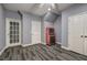 Basement area with gray walls, patterned carpet, and a door to the outside at 3759 Maryhill Nw Ln, Kennesaw, GA 30152