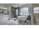 Luxurious bathroom featuring a freestanding tub, glass-enclosed shower, and stylish fixtures for ultimate relaxation at 3759 Maryhill Nw Ln, Kennesaw, GA 30152