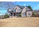 Elegant two-story brick home featuring a covered front porch and well-manicured landscaping, offering classic curb appeal at 3759 Maryhill Nw Ln, Kennesaw, GA 30152