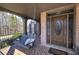 Cozy covered porch showcasing a swing seat, brick accents, and an attractive front entrance at 3759 Maryhill Nw Ln, Kennesaw, GA 30152