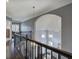 Second story hallway with an arched architectural feature, hardwood floors, and decorative lighting at 3759 Maryhill Nw Ln, Kennesaw, GA 30152