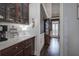 Hall view into grand entry featuring wood cabinetry, marble countertops, and modern decor at 3759 Maryhill Nw Ln, Kennesaw, GA 30152