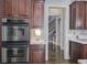 Updated kitchen boasts stainless steel double ovens, custom cabinetry, and white marble countertops at 3759 Maryhill Nw Ln, Kennesaw, GA 30152