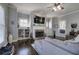 Inviting living room featuring a stone fireplace, custom built-ins, and lots of natural light at 3759 Maryhill Nw Ln, Kennesaw, GA 30152