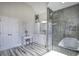 Main bathroom features a double shower and stand alone tub, and marble floors at 3759 Maryhill Nw Ln, Kennesaw, GA 30152