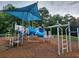 Community playground with a blue shade, slide, stairs, and ladders for children at 3759 Maryhill Nw Ln, Kennesaw, GA 30152