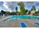 Community swimming pool with lounge chairs and lush landscaping, with a clubhouse in the background at 3759 Maryhill Nw Ln, Kennesaw, GA 30152