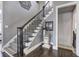 Elegant staircase with patterned runner, iron railings, and a decorative table with decor at 3759 Maryhill Nw Ln, Kennesaw, GA 30152