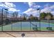 Outdoor tennis courts with green and blue surface, surrounded by a black fence and lighting at 3759 Maryhill Nw Ln, Kennesaw, GA 30152