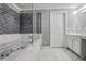 Luxurious bathroom with soaking tub, marble tile, walk-in glass shower, and modern vanity at 409 Angier Ne Ct, Atlanta, GA 30312