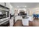 Gourmet kitchen with stainless steel appliances, island, and adjacent dining area at 409 Angier Ne Ct, Atlanta, GA 30312