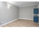 Stylish living room showcasing a blue safe door, light wood floors, and neutral walls at 409 Angier Ne Ct, Atlanta, GA 30312