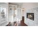 Cozy living room featuring built-in bookshelves, a marble fireplace, and hardwood floors at 409 Angier Ne Ct, Atlanta, GA 30312