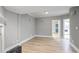 Spacious living room with modern light fixtures, gray walls, and light wood flooring at 409 Angier Ne Ct, Atlanta, GA 30312