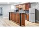 Wet bar area with wooden cabinets, granite countertops, and modern appliances at 409 Angier Ne Ct, Atlanta, GA 30312