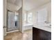 Bright bathroom featuring a glass shower, soaking tub, and a double vanity with white countertop at 5113 Rapahoe Trl, Atlanta, GA 30339