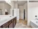 Spacious bathroom showcasing a double sink vanity, a large mirror, and separate door openings at 5113 Rapahoe Trl, Atlanta, GA 30349