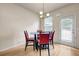 Cozy dining area with a contemporary table set, a chandelier, and natural lighting at 5113 Rapahoe Trl, Atlanta, GA 30349