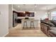 Open kitchen featuring an island with seating, stainless steel appliances, and wood floors at 5113 Rapahoe Trl, Atlanta, GA 30339