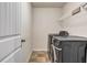 Functional laundry room with a modern washer and dryer, and ample shelving at 5113 Rapahoe Trl, Atlanta, GA 30349