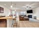 Open-concept living area featuring a kitchen island, hardwood floors, and a cozy fireplace at 5113 Rapahoe Trl, Atlanta, GA 30339