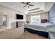 Main bedroom with a tray ceiling, TV, and a large window offering plenty of natural light at 5113 Rapahoe Trl, Atlanta, GA 30339