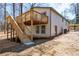 Exterior of home featuring new wooden stairs, elevated back deck, and neutral siding at 526 Myrtle St, Villa Rica, GA 30180