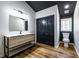 Bathroom with black ceiling, wooden floors, modern fixtures and a toilet and sink at 526 Myrtle St, Villa Rica, GA 30180