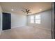 Bright, neutral bedroom features a ceiling fan and two windows letting in natural light at 526 Myrtle St, Villa Rica, GA 30180