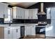 Modern kitchen featuring stainless steel appliances, quartz countertops, and sleek white cabinets at 526 Myrtle St, Villa Rica, GA 30180