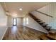 Bright and airy living room boasts hardwood floors and an open staircase design at 526 Myrtle St, Villa Rica, GA 30180